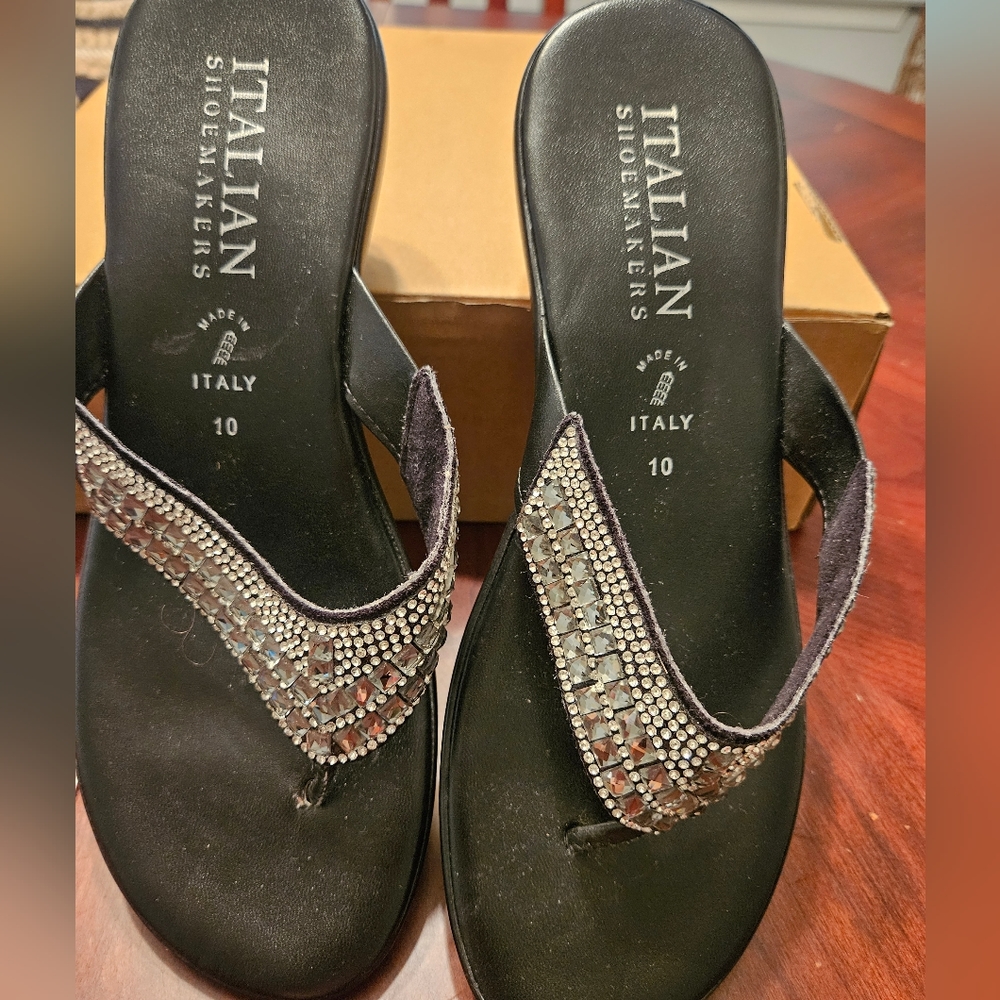 Women black Italian leather flip flops with silver sequins.